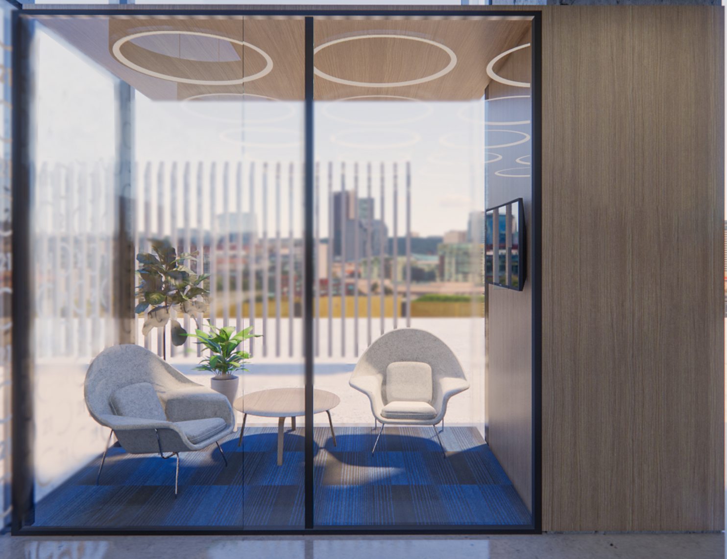 Sala de reuniones con puertas de cristal y butacas blancas