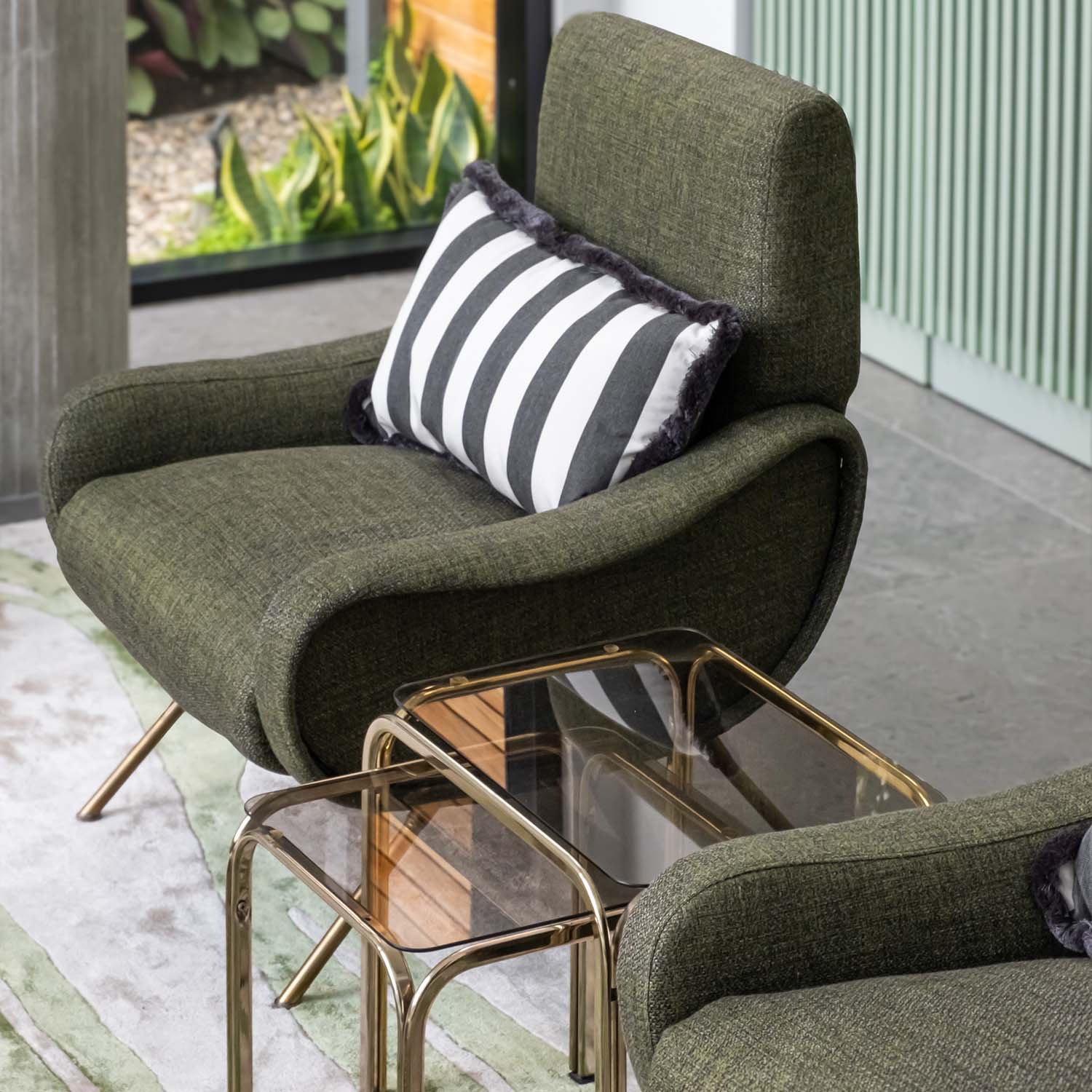 A cozy nook with green armchair