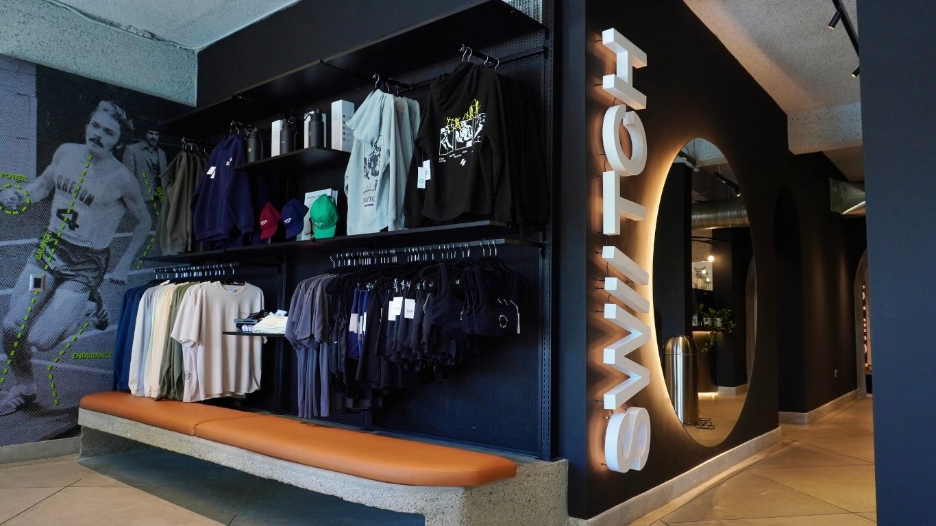 Interior of SWIITCH Gym in Altamira Caracas, designed by Ana Volante, featuring a modern reception with black and concrete details.