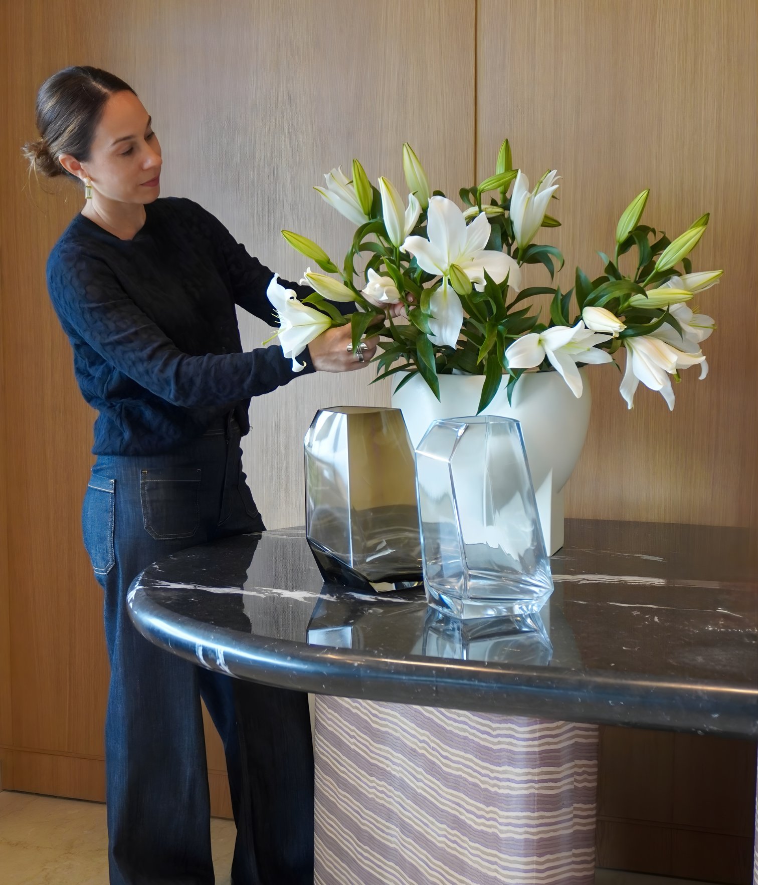 Interior designer Ana Volante arranging flowers during the styling process of a residential interior project.